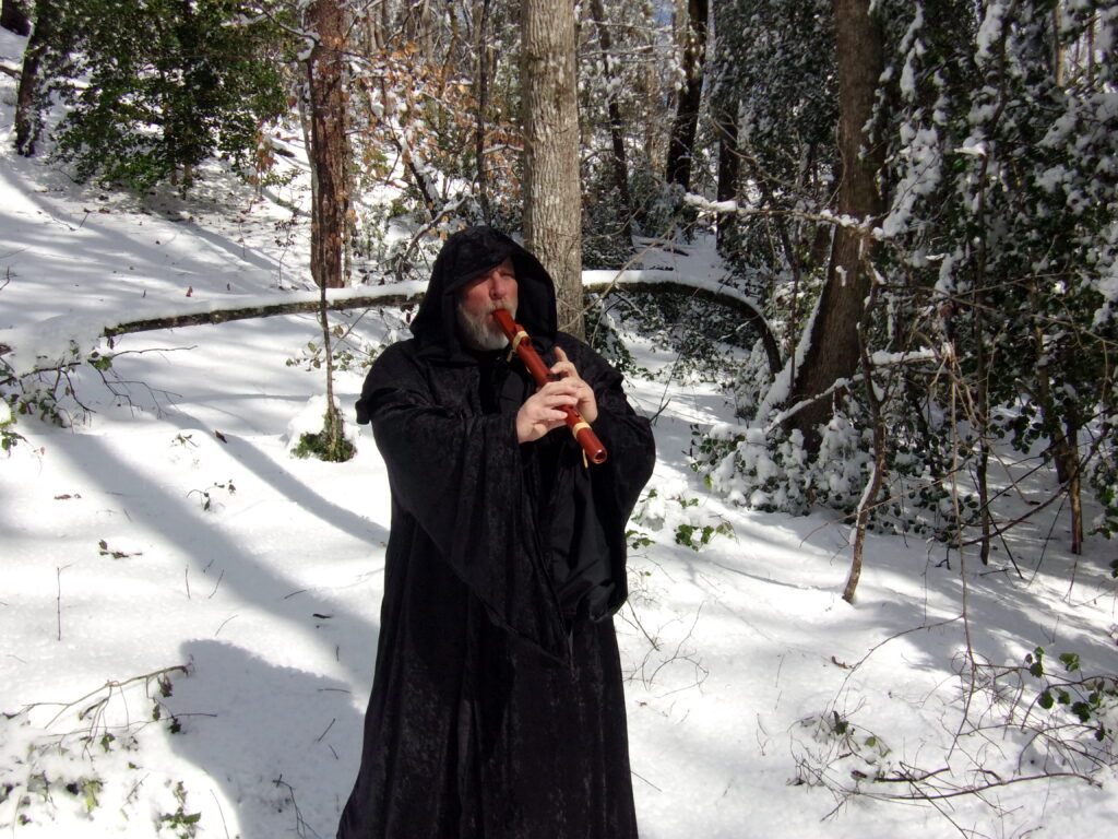 Sencha playing the flute in the snow